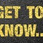 "Get to know" written in yellow on pavement
