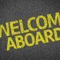 Welcome Aboard written in yellow paint on pavement
